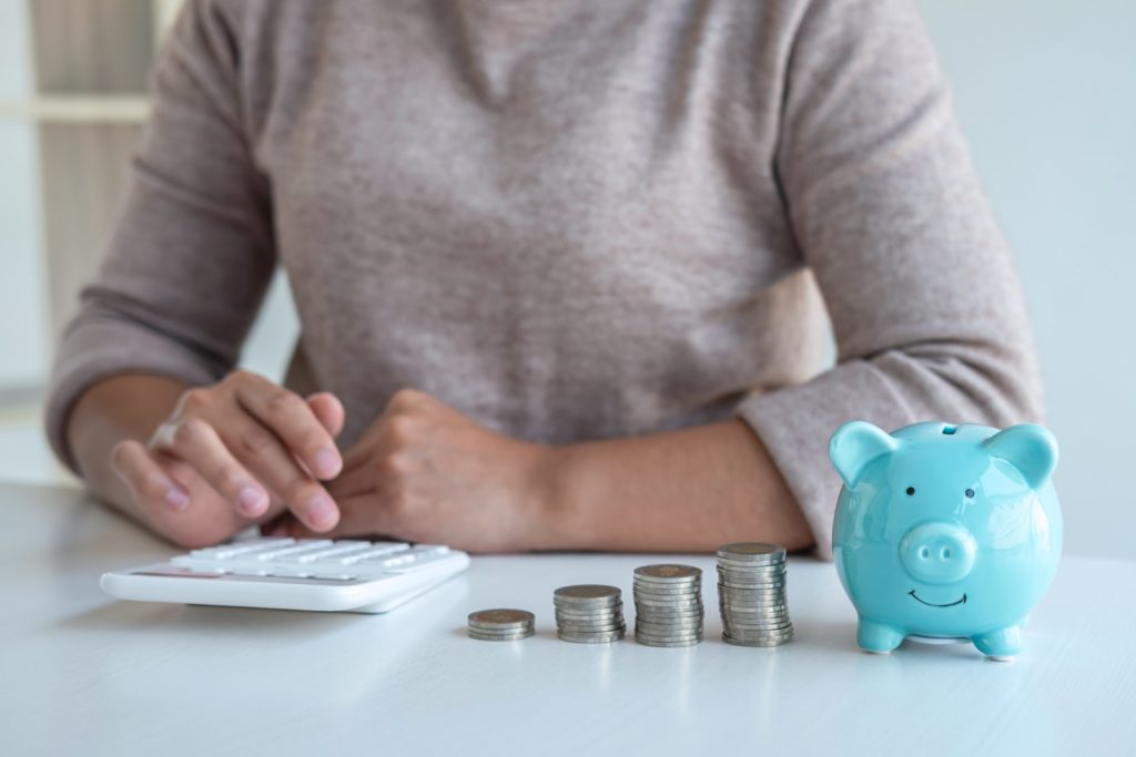 Young woman and piggy bank to planning growing saving strategy with pile coins for future plan fund